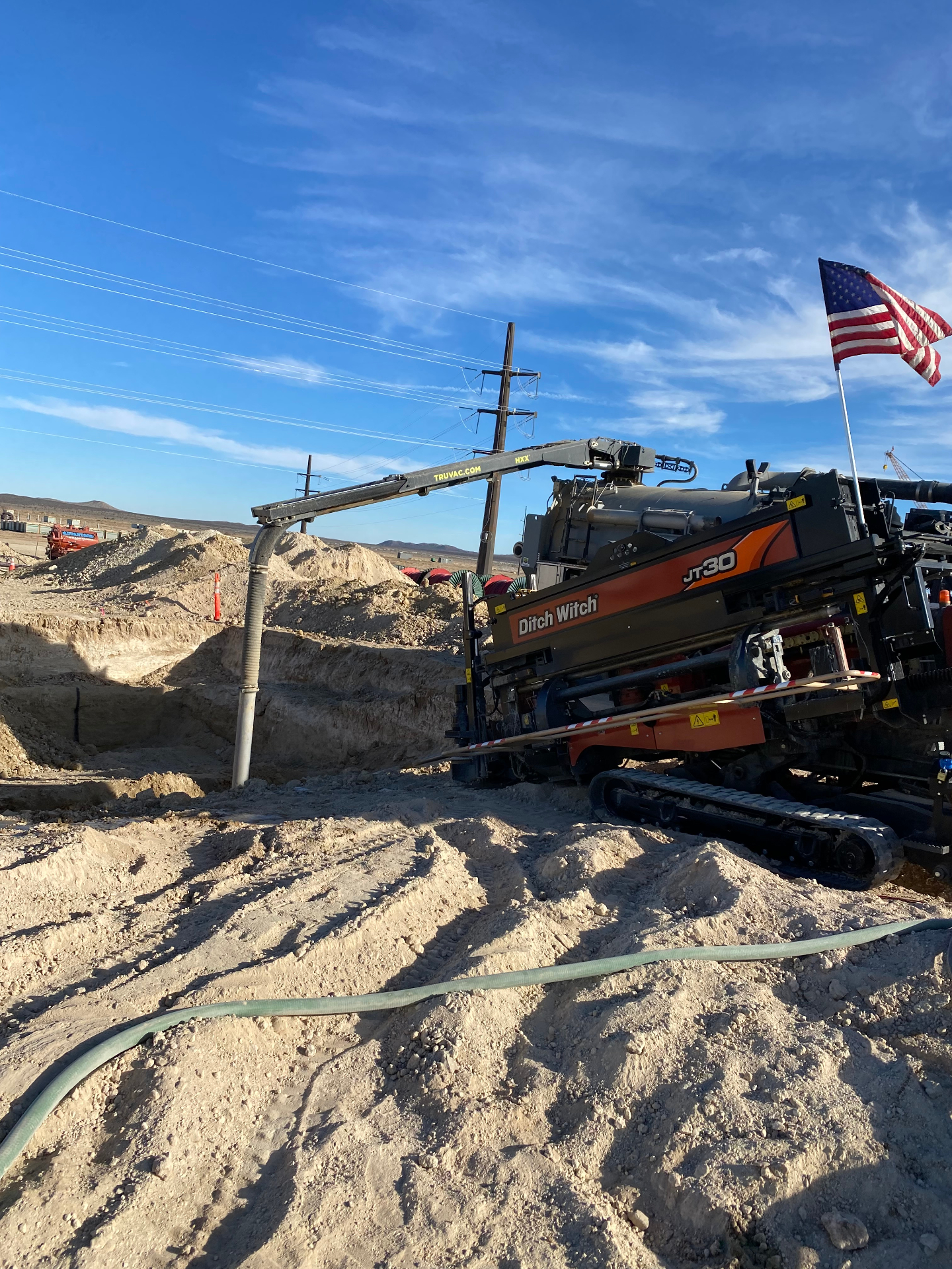 JT30 rig boring beside a shored pit with TRUVAC support in the High Desert