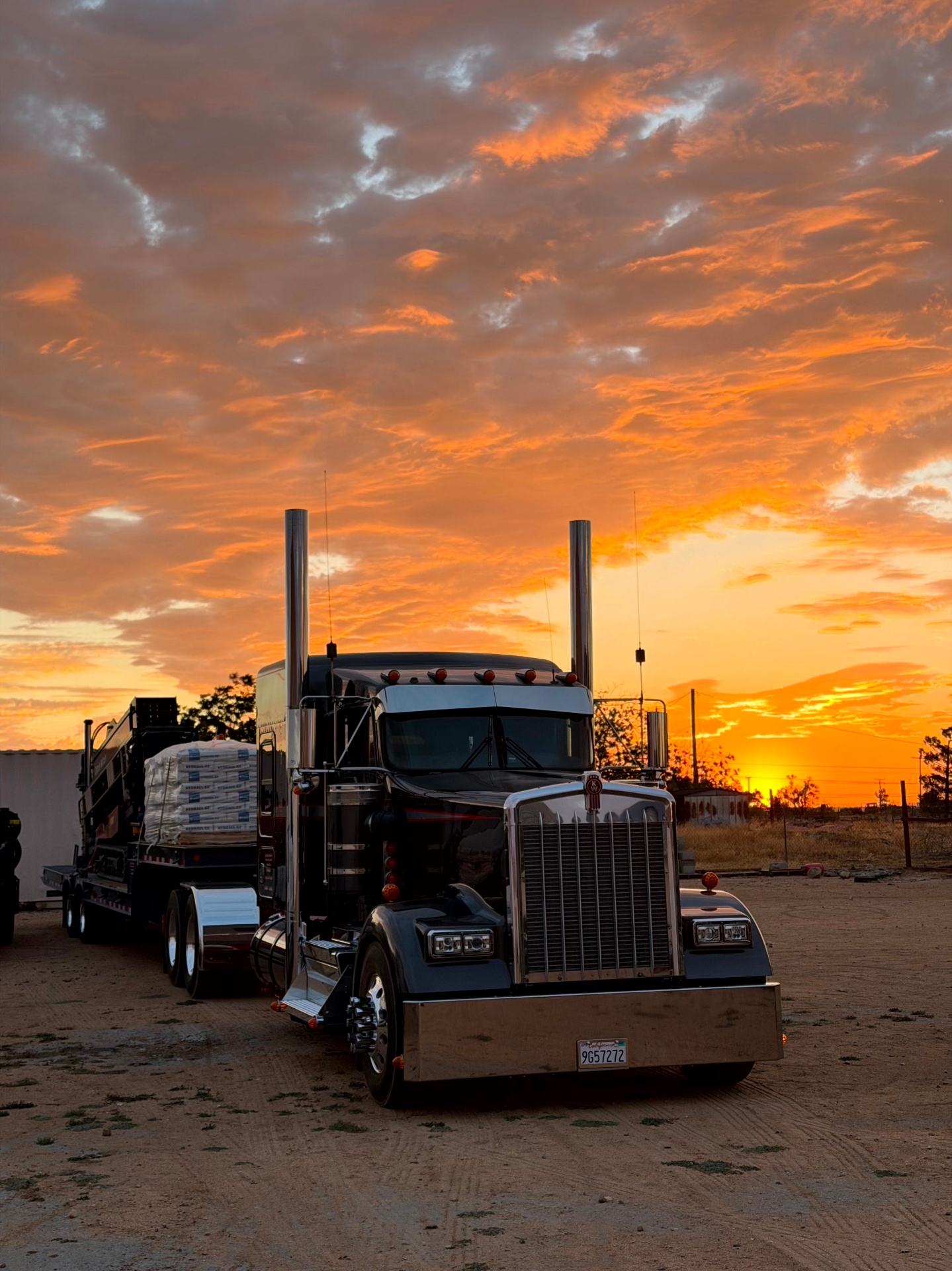 Kenworth loaded with the rig and Hydraul-EZ drilling fluid at High Desert sunset