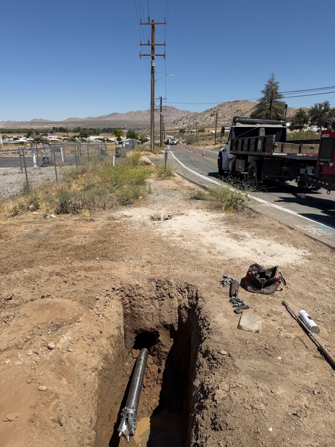 Bore pit with drill stem exiting along desert roadway