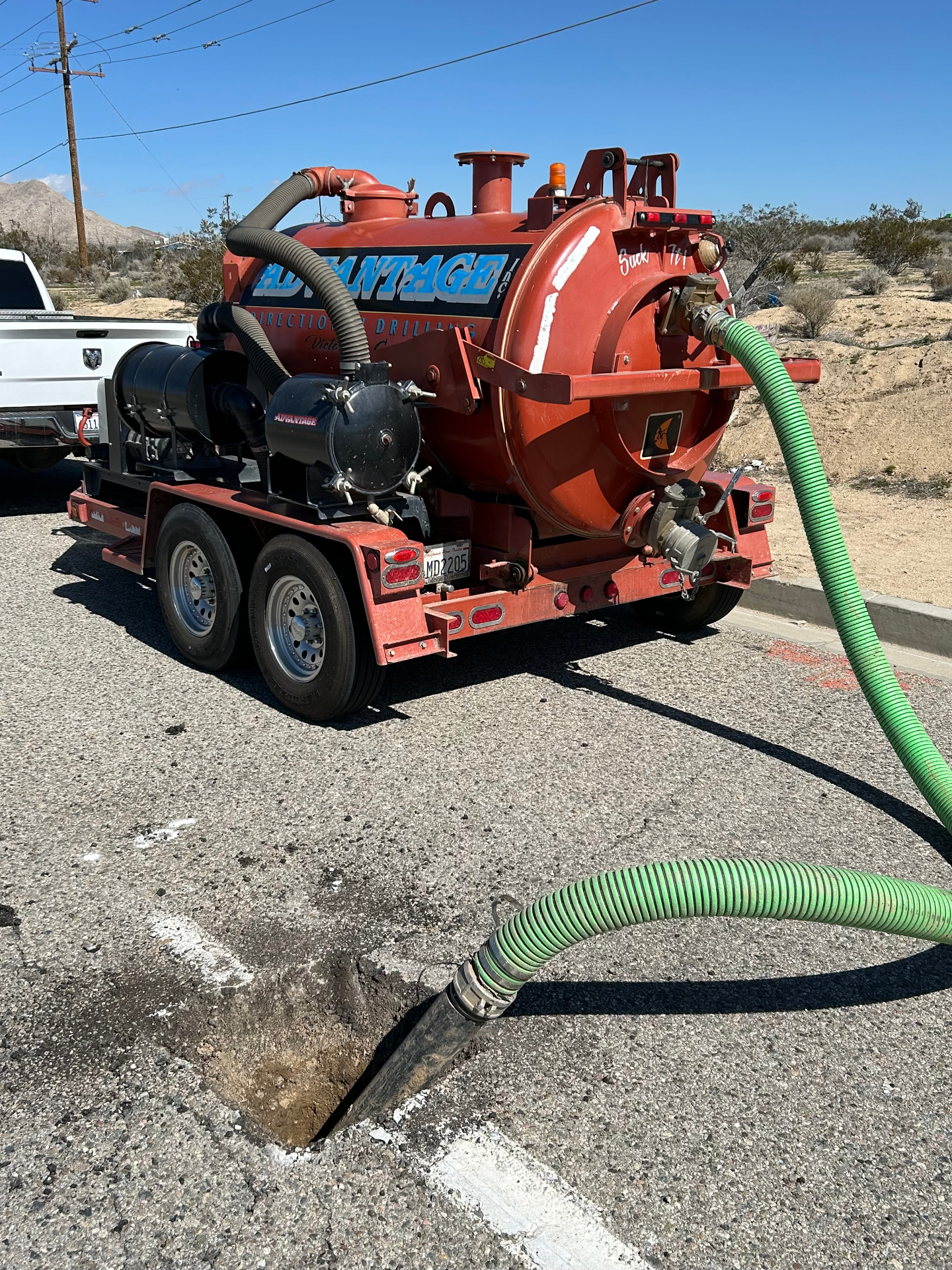 Advantage vac trailer potholing curbside in Victor Valley