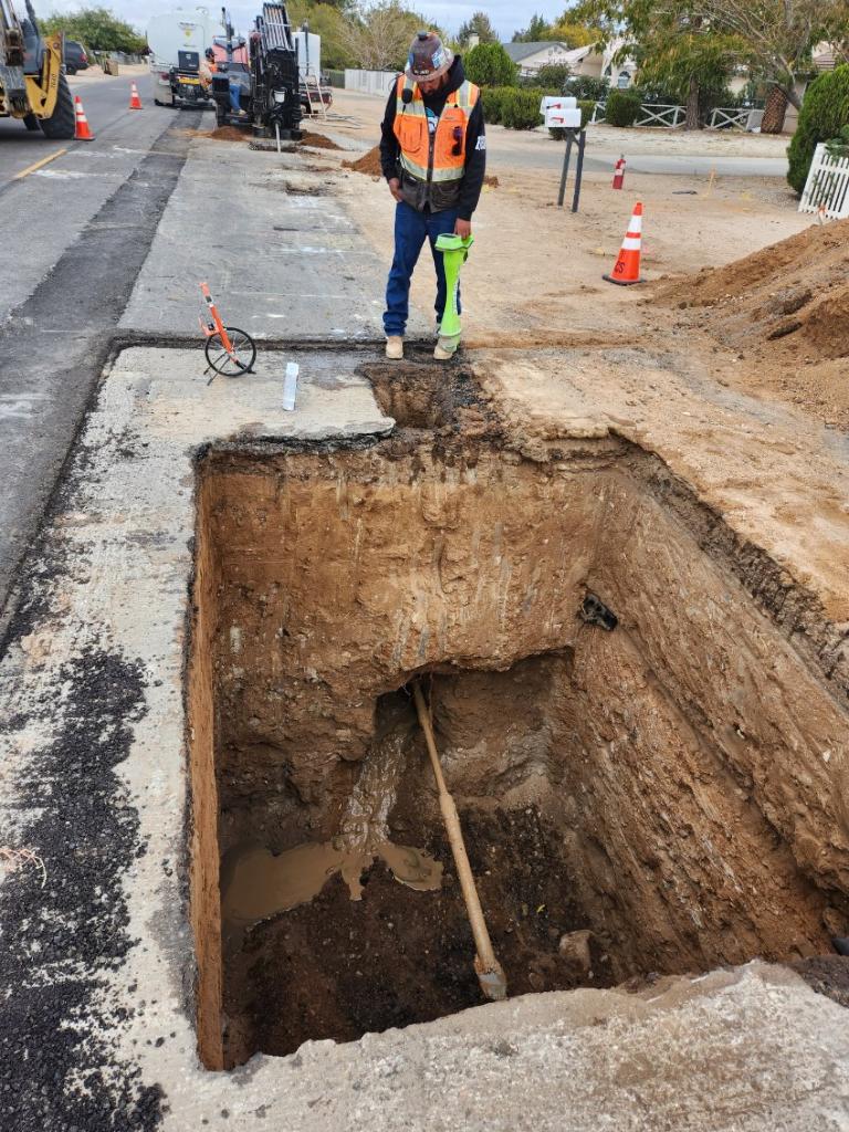 Subsite Marksman locator work over a shored pothole in a residential street