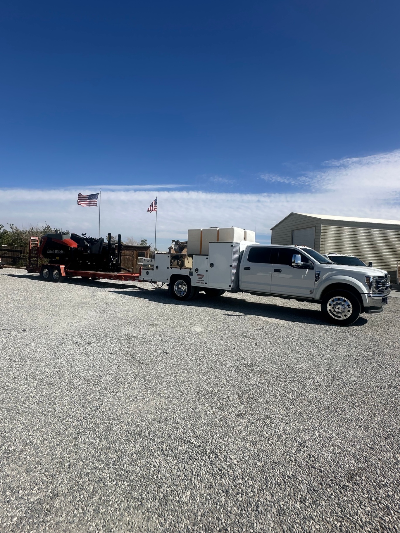 Truck and trailered rig ready to mobilize under the flag